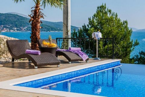 Stunning villa on the 1st row to the sea, located just 20 meters from the sea opposite high class yachting marina, a picturesque town only 15 km from the UNESCO World Heritage site of Trogir. The villa is conveniently situated 10 km from Split Intern...