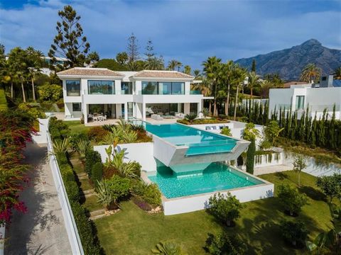 Distributed over 3 levels, this fabulous villa has 6 bedrooms, 6 super modern bathrooms and 2 toilets. It welcomes you into an impressive entrance hall with double-height ceiling, which leads to a large open-plan living area. The large, voguish livin...