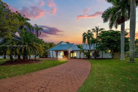 Beautiful, sprawling estate residence located on a cul-de-sac * 2019 metal roof with a modern style porte cochere * Full impact windows & doors * Spacious living, dining and family rooms all with stunning tongue & groove vaulted ceilings * Plantation...