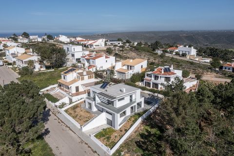 Located in Aljezur. An attractive modern 4 bed 247m2 villa on a well positioned 495m2 plot with swimming pool and garage with distant ocean views from the upper level balconies located in the urbanisation of Espartal within walking distance of Monte ...