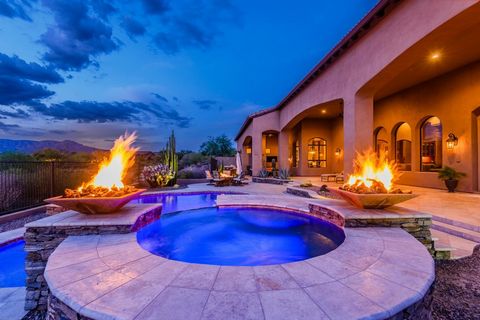 This elegant North Scottsdale custom estate is located on a private lot in a gated community. Outside, there are exquisite mountain and sunset views with open desert space behind. The expansive travertine covered patio, heated solar pool and spa, bui...