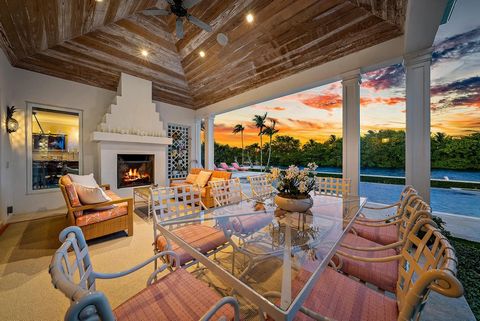 The Epitome of Palm Beach Chic on Everglades Island. This house is a true Bermuda style house with 150 feet of direct waterfront. Most ceilings are vaulted with pickled wood to create a sophisticated island atmosphere. There are multiple outdoor livi...