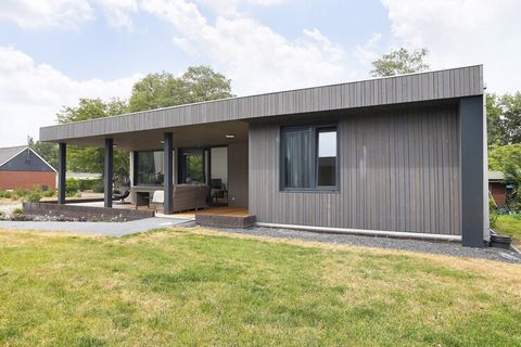 The modern design of this accommodation immediately catches the eye. Not only the shape but also the beautiful materials give it a luxurious appearance. The huge windows, the sliding door and the beautiful height make the living room a wonderful plac...