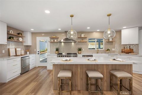 Welcome to this exquisite, fully remodeled luxury home nestled on a cul-de-sac in the serene neighborhood of Stratford Ridge in the heart of Laguna Hills. Pictures don't do this home justice! This stunning six-bedroom (all bedrooms have closets!), th...