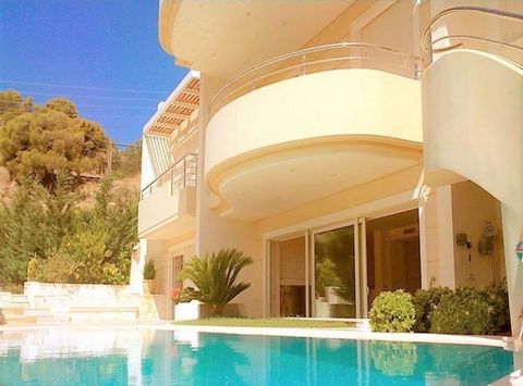 Vouliagmeni Villa 630sq.m., 4 levels, 4 bedrooms(2 master), 8 bathrooms, 1 wc, 2 kitchens, 2 living room areas, independent heating petrol, 2 fireplaces, a/c, solar heater, security door, security alarm system , double glazed windows, elevator, balco...