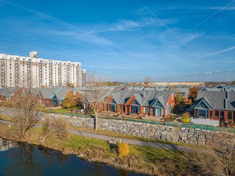 Nestled directly along the banks of the St. Lawrence River, an exceptional semi-detached townhouse in the impressive Village Libert sur Berges project. This stunning unique property, offering breathtaking waterfront and city views, features cathedral...