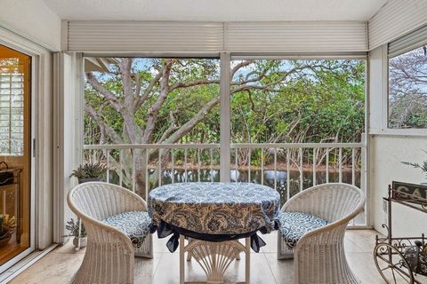 Welcome to an elegantly updated coach home in the prestigious, all-ages, non-membership Boca Country Club. You're greeted with laminate plank flooring; airy plantation shutters; vaulted ceilings in the living/dining area, and neutral, tasteful enhanc...