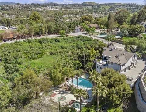 Nestled in a Hollywood Hills-inspired setting, this estate offers a sanctuary where city life fades away, and the beauty of nature takes center stage. Situated on a half-acre lot, this luxurious home is designed to embrace the natural elements and sh...