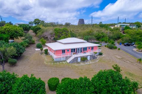 Island villa located in the heart of one of St. Croix's beloved and tranquil beachfront communities, Green Cay on Ms Bea Road. Boasting three spacious bedrooms and two baths, this villa features soaring vaulted ceilings, a wrap-around veranda complet...