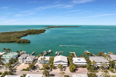 This waterfront paradise has everything you could desire! Enjoy breathtaking sunsets every evening, ample dockage, and plenty of space for family and friends to gather. This 5-bedroom, 5-bathroom concrete home offers numerous comfortable living areas...