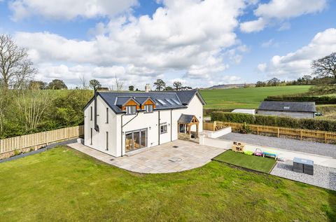 Located in Middle Green, just a mile from Wellington Town centre, this charming home rests on the gentle foothills of the Blackdown Hills, offering views of Wellington Monument. Meticulously extended and enhanced, this beautiful home seamlessly blend...