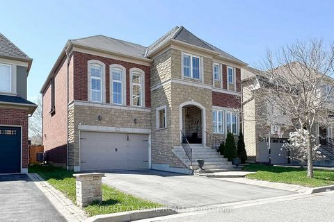 Absolutely Stunning Home Located In One Of Ajax's Most Sought After Neighbourhoods. Stone and Brick Exterior On The Front, And No Homes Directly Behind. Exquisitely Angled Brazilian Tiger Hardwood Throughout Entire House!. Beautifully Designed Kitche...