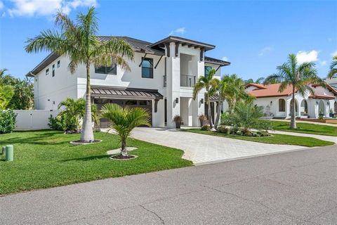 This exquisite 2021 home, custom-built by JR Structures, impresses from the moment you arrive. Spanning 6720 square feet under roof and stands amongst renowned waterfront mansions on one of the most prestigious streets in desirable Tierra Verde. With...