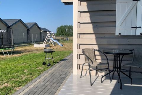 New holiday cottages for 4 people are located in a quiet and peaceful housing estate, 10 minutes' walk to the sea, 2 minutes to Lake Wrzosowskie and 5 minutes to the center of Dziwnówek. On the terrace of each house there are two tables and four chai...