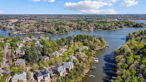 Indulge in the epitome of waterfront luxury living in Tega Cay. This exquisite residence exudes opulence at every turn, from its grand entrance with craftsman-style arched casement entries to its meticulously designed interiors. Revel in the culinary...