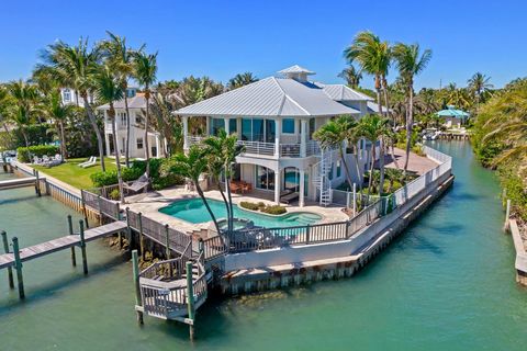 This extraordinary Key West-style haven, zoned for commercial use, is a boater's dream property. With a mid-tide depth of 7' and a self-contained captain's suite, bring your 70-90' sportfish AND 4-6 center consoles. Situated on the Intracoastal Water...