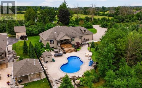 This charming 4-bedroom bungalow, situated just outside the city, offers the perfect blend of tranquility and convenience. Nestled on a 1.11-acre lot, the property features a lush outdoor oasis with in-ground pool & hot tub, and ample space for outdo...