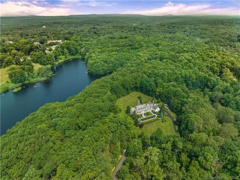 Welcome to a truly exceptional New Canaan architectural masterpiece built in 2004, nestled on a majestic private lane occupied by only 6 estates, enveloped by serene forests and 48 acres of reservoir conservancy. This picturesque estate offers a tran...