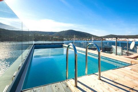 A beautiful stylish villa of modern architecture located on the first row to the sea, in a small picturesque place near Trogir and Marina, known for its beautiful bays and beaches! The villa is 50 meters from the center of the town, where there are r...