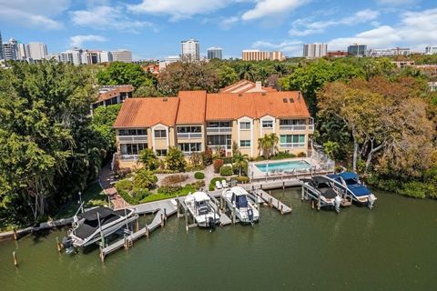 WOWZA! ~END UNIT~ 4 BEDROOM/3 BATH/ 2 OVERSIZED CAR GARAGE AND 2 ASSIGNED PARKING SPACES ON THE WATER WITH A PRIVATE DOCK! ~BRING YOUR BOAT, BIKE TO THE BEACH OR WALK TO AMAZING RESTAURANTS! West of the trail~ waterfront condo on the Hudson Bayou wit...