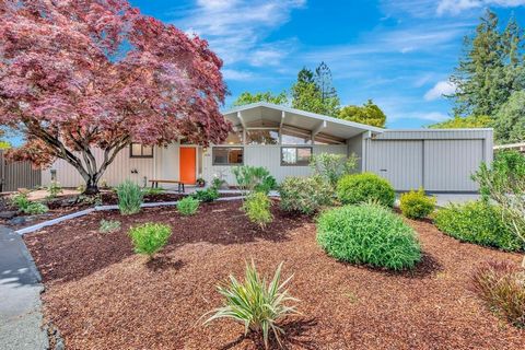 This striking mid-century modern Eichler is situated at the end of a peaceful cul-de-sac in the heart of Greenmeadow (Walnut Grove), a prime neighborhood in south Palo Alto. The many highlights include Eichler's original mahogany paneling, high beame...