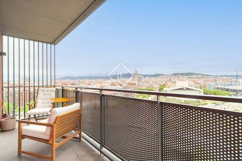 This apartment is located on the upper floor of a building built in 2012, offering impressive panoramic views of the city of Barcelona. We access the property through a entrance hall that separates the night area . On the right hand side we find the ...