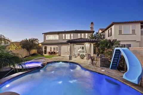 Enjoy this STUNNING POOL entertainer’s home, with an 8,795 SqFt, CORNER lot and popular floor plan, 5 bedrooms + Office & 2 fireplaces-including one bed and bath on the main level- featuring a sparkling saltwater Pool & Spa with waterfalls and waters...