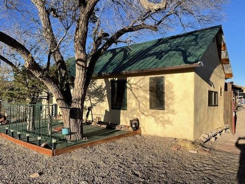 Nestled in the heart of New Mexico's Land of Enchantment, this cozy two-bedroom, one-bath Adobe frame home offers the perfect off-grid retreat. With a wood stove and propane heat, this home provides warmth and comfort year-round. The durable metal ro...