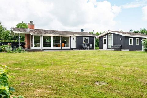 This holiday home is situated close to Sminge Sø, through which the river Gudenåen flows. The cottage is furnished with two good bedrooms and an open kitchen in connection with the living room. There is direct access from the living room to the terra...