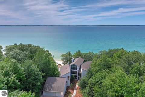 Looking for the perfect secluded getaway in a wooded lakeside locale that is still easy to get to by plane? Ensconced in a lush surrounding of 6.5 acres of matured oaks, maples and pines, this stunning house in Elk Rapids, MI boasts over 200 feet of ...