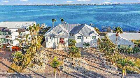 Truly A World of Its Own - Delightful Bay Front Living with sweeping views of the crystal clear waters of Anna Maria Sound and Tampa Bay. This Elevated - One level, Custom built coastal residence is a tribute to aesthetic design, location and impecca...