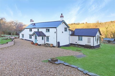 We are delighted to offer for sale this modernised, extended and refurbished character cottage in the middle of its own one acre plot. Huish Moor is a peaceful, rural valley location with a group of approximately ten properties. You enter through a c...