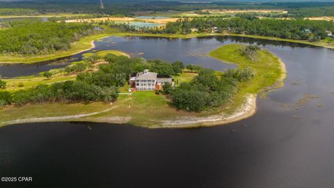 Stunning Southern Lakefront Estate on 32 Acres with 360 Water Views! Nestled just north of Panama City, Florida, this extraordinary 32-acre estate on freshwater River Pond is a remarkable gem. As you enter this lakefront estate, you're greeted by a s...