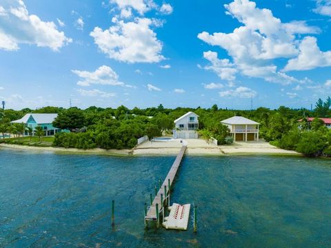 Stunning Sugarloaf Retreat with private sandy beach, sparkling pool, and sprawling dockage! This turnkey, coastal home offers elevated seaside living, with designer finishes and a resort feel. Entertain like never before in the bright and spacious ma...