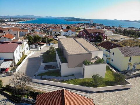 Luxury semi-detached villa under construction with a panoramic view of the sea and islands in the popular tourist resort of Vodice, Sibenik area. Located in a quiet area, only 900 meters from the center and 1100 meters from Plava Plaža, one of the mo...