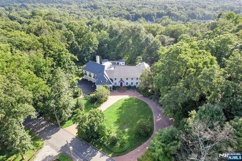 Welcome to 11 Woodfield Lane!A distinguished estate offering unparalleled luxury and privacy.This expansive 10,000(apprx)square foot residence is situated on over 3 acres of meticulously landscaped grounds.The home features 6 bedrooms and 7. 2 bathro...