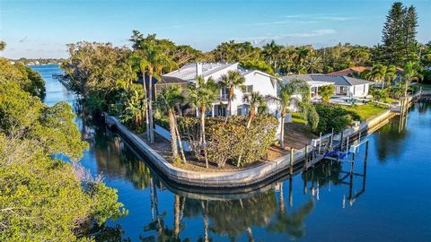 Welcome to the epitome of Coastal Luxe living on Siesta Key! This exceptional 3 or 4 bedroom, 6 1/2 bath home, complete with an office and extraordinary outdoor living, is a true gem situated on 230 feet of canal just a short walk from Crescent Beach...