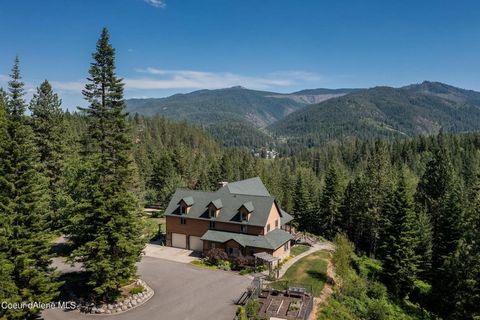 Discover the epitome of luxury living in this majestic 20-acre estate nestled in Pinehurst, Idaho. This exquisite 5,341 square-foot home, built in 2003, offers stunning mountain views from the comfort of an open concept living space, accentuated by a...