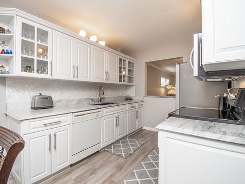Grove Isle, a vibrant 55+ pet friendly community, welcomes you to this exquisite ground-level unit. With elegant marble countertops, white cabinets, and chic backsplash, the kitchen shines. Spacious walk-in closets enhance both bedrooms. Durable lami...