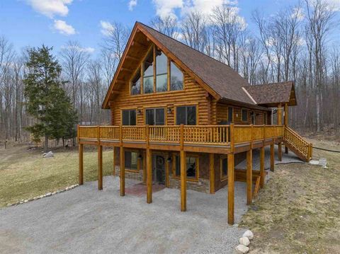 Tucked away and nestled among 33 acres of serene, wooded rolling hills, this newly completed constructed log cabin offers a perfect blend of rustic charm and modern luxury. As you approach the property, the expansive natural landscape envelops you, c...
