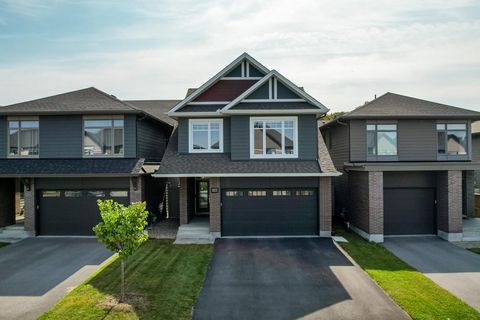 Discover your dream home in the coveted Wateridge community! This detached gem showcases an open concept living space that highlights the extensive upgrades in the home, including hardwood flooring and quartz countertops. The modern chef's kitchen, e...