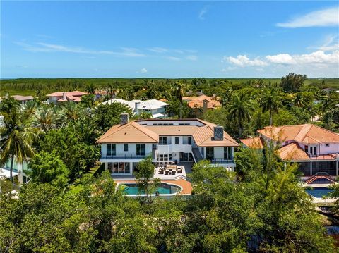 Fully renovated 3-story waterfront home in the highly desirable guard-gated community of Hammock Oaks. The main floor includes a spacious living room with 22-foot ceilings, bordered by a two-sided wood fireplace, the dining room, a 1200-bottle wine c...