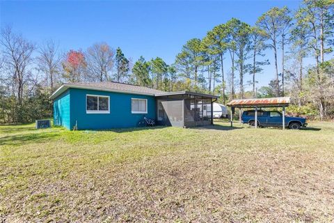 Set on a spacious 1.2-acre lot, this inviting home combines modern updates with the tranquility of country living. Built with durable concrete block construction and featuring a newer roof and windows, this property is designed for longevity and ener...