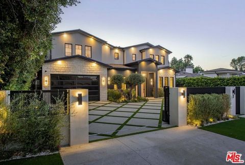 Welcome to this stunning new gated estate situated south of the Boulevard, in prime Encino. As you step through the grand entrance, you're greeted by an expansive open floor plan bathed in natural light. The formal living room, featuring a cozy firep...