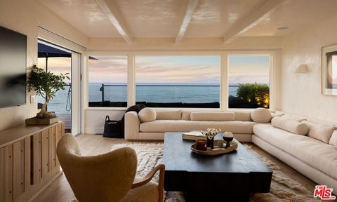 Nestled within the exclusive and historically rich Malibu Colony community, this newly designed beach-front house 