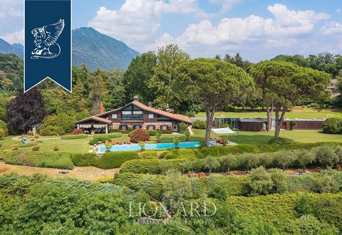 This stunning villa with a park and a panoramic 25-meter-long pool with a view of the Borromean Islands is for sale by Lake Maggiore, in the renowned town of Laveno Mombello. Built in 1964, then renovated and perfectly maintained, this property consi...
