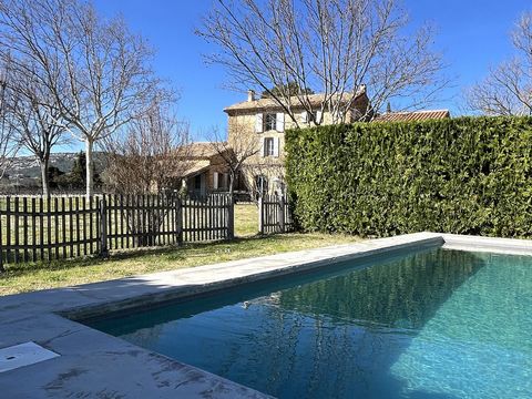 In the heart of the Beaumes de Venise vineyards, in a rare location where the view is drawn to both the Dentelles de Montmirail and the Mont Ventoux and sheltered from all nuisances, this stone building of 425 m2 of living space on 6600 m2 of land an...
