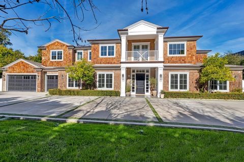 Luxurious Hamptons-inspired Contemporary Estate located in Tarzana south of the boulevard. Set back from the street with a circular driveway to provide the true estate feel and behind gates with tall ficus trees and mature landscape to create the ult...