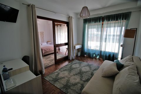 A spacious suite only 800 meters from the center of Setubal. Suite has a room with a double bed, a living room, a private bathroom, a big balcony, two flat TVs, AC, and a mini fridge. Use of shared kitchen and living/dining room. In front of the hous...