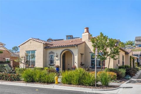 To blend with its contemporary Spanish style exterior, this dramatic, single-story view home in the rolling hills of Rancho Mission Viejo, offers a stunning interior highlighted by an 11-1/2 foot high, rustic-beamed Great Room. Flooded with natural l...